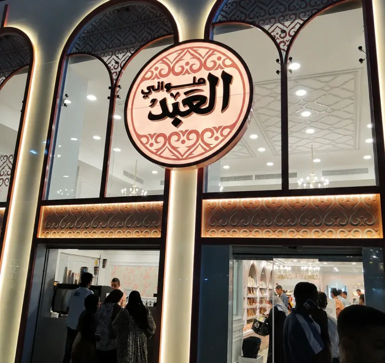 لقطة مقربة لواجهة ولافتة فرع حلواني العبد مع تصميم مداخل تجارية متكاملة ومؤمنة بأحدث أنظمة الأبواب من جاتكس